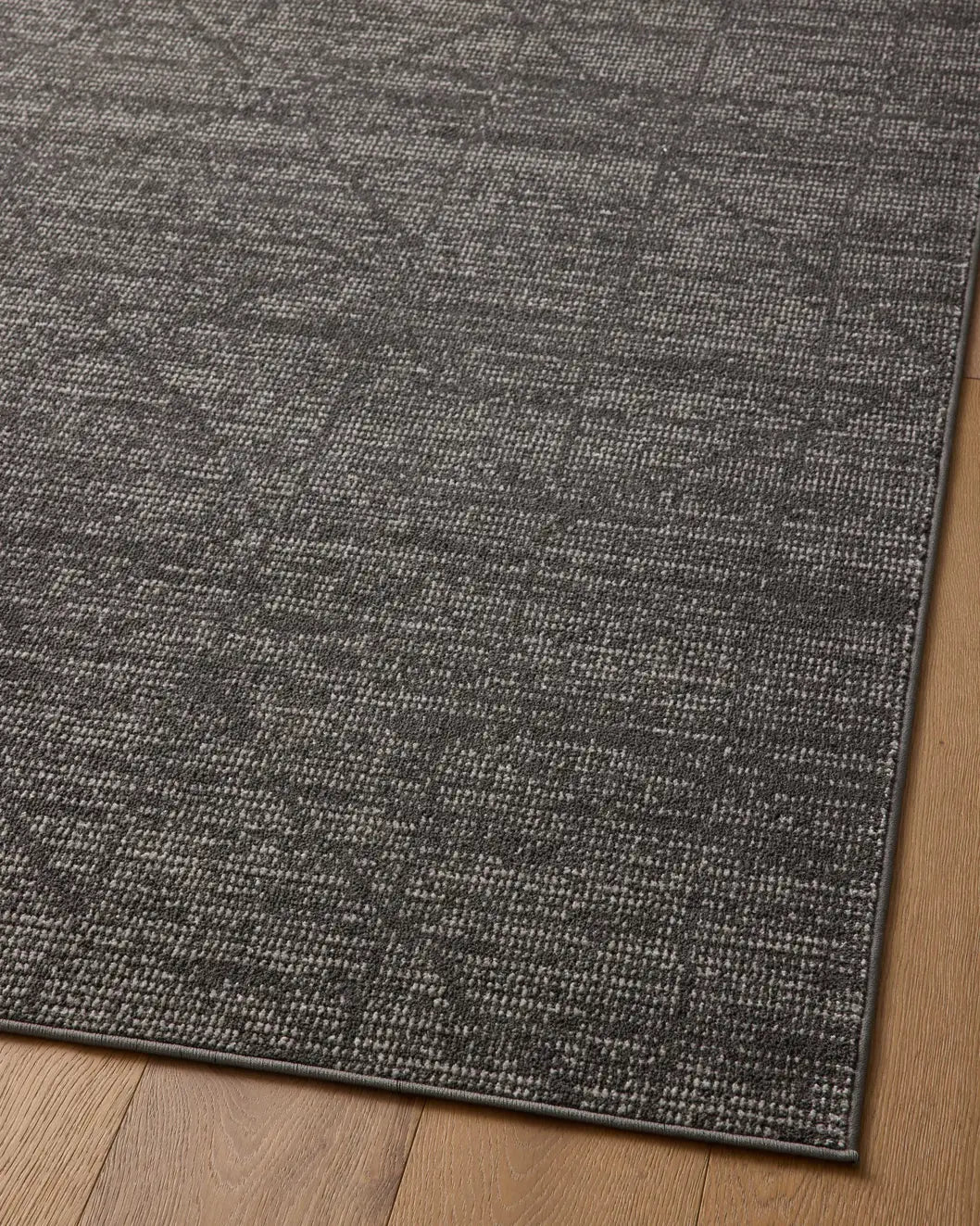 Loloi Kamala Kam-06 Charcoal/Ivory Rug - angled corner on wood