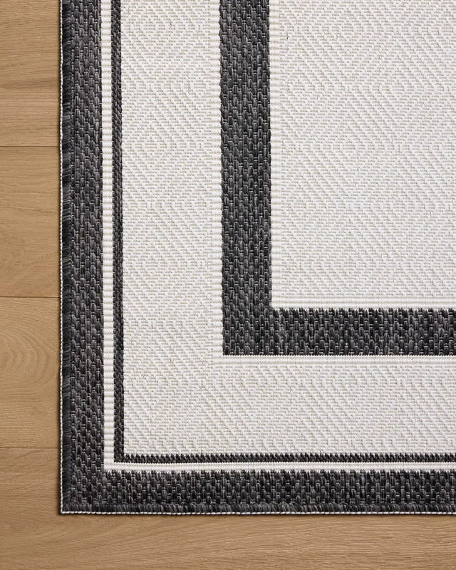 Loloi Easton ESN-11 Onyx / Ivory Rug - corner on wood