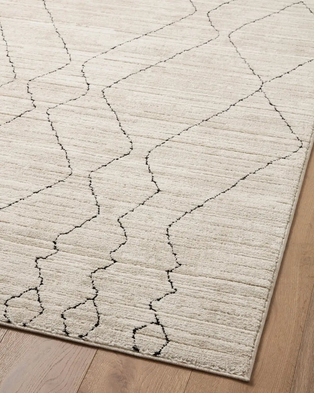 Loloi Darby Dar-03 Sand/Charcoal Rug - angled corner on wood