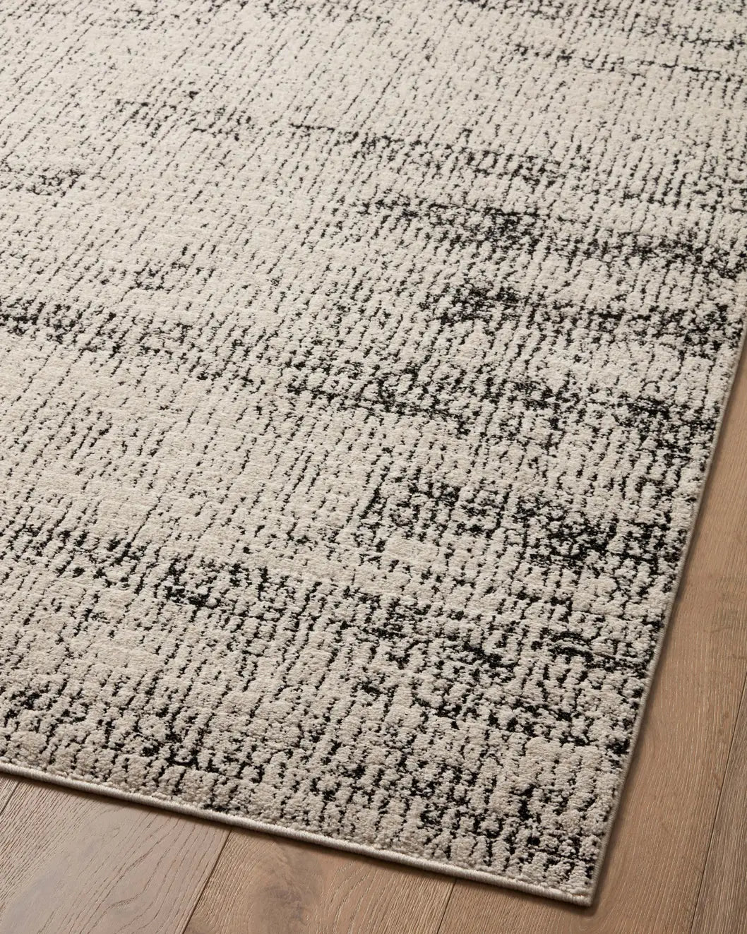 Loloi Darby Dar-02 Oatmeal/Charcoal Rug - angled corner on wood