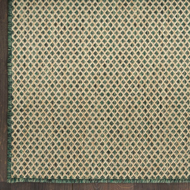 Green area rug close-up showing diamond lattice pattern with textured, flat weave