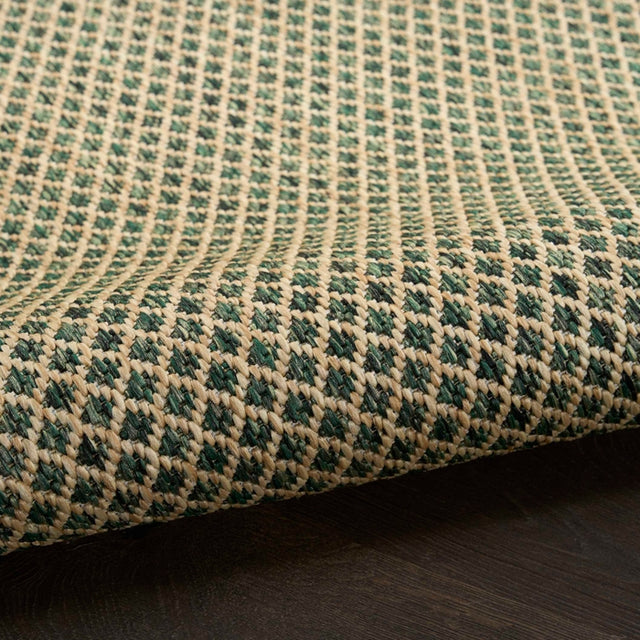 Close-up of green rug weave with diamond lattice pattern and textured surface detail