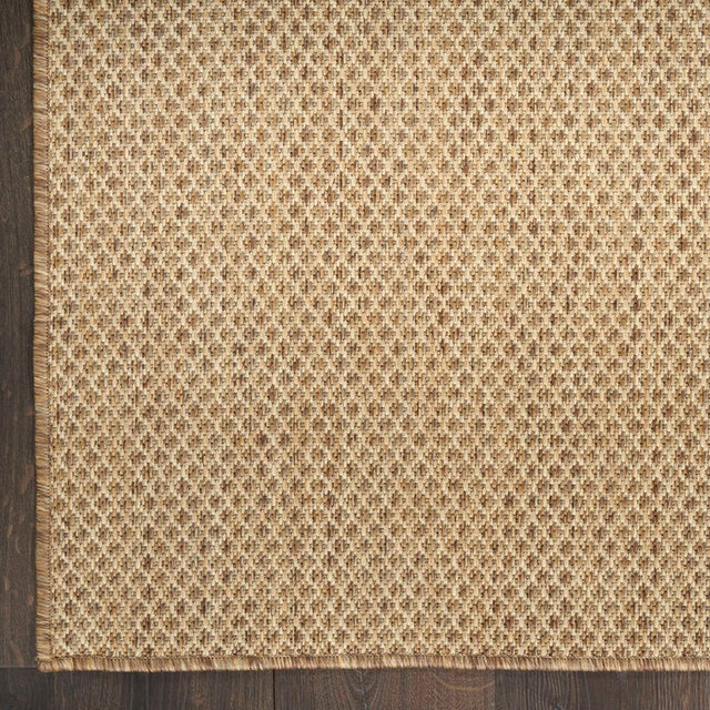 Tan jute rug with dense woven diamond pattern close-up