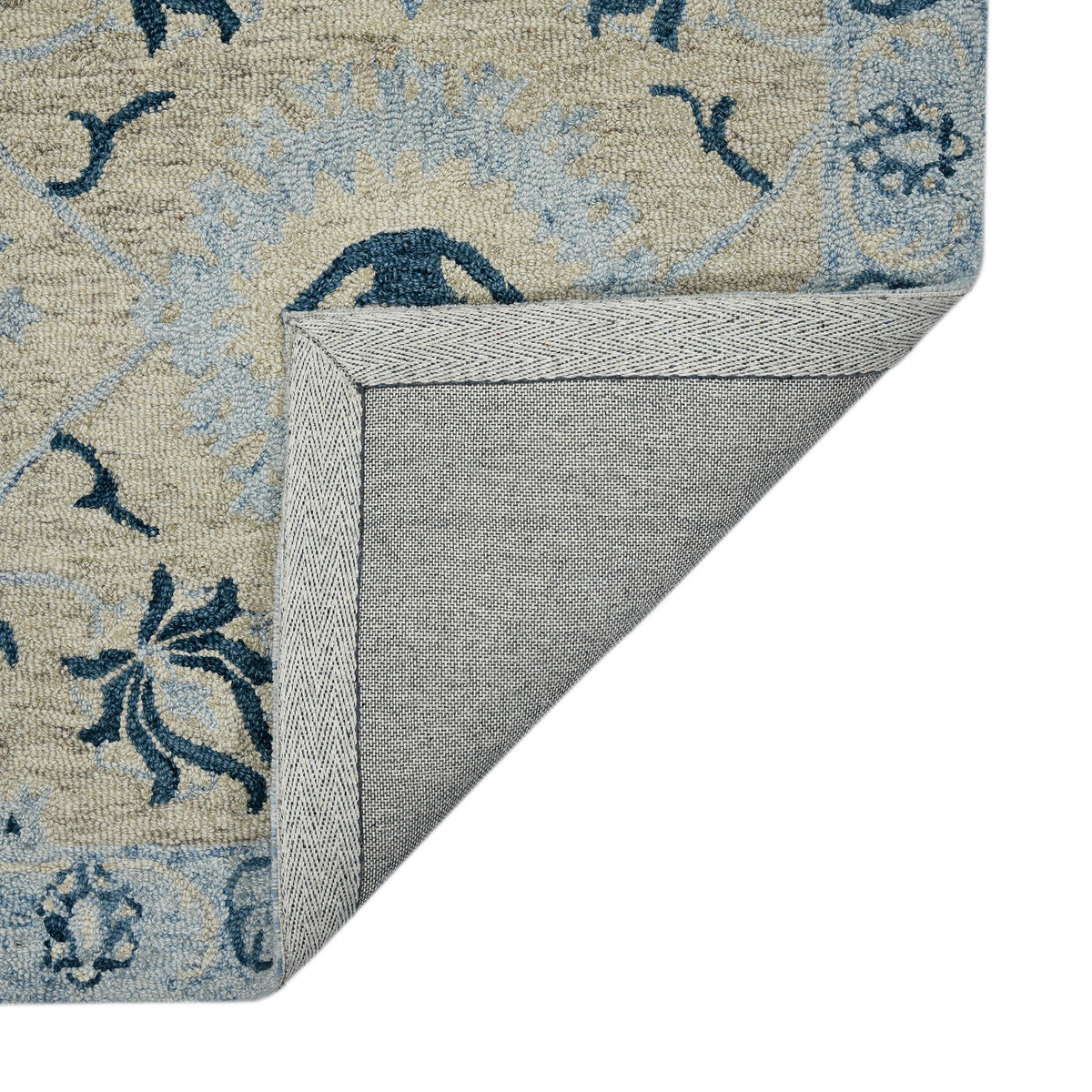 Hand-hooked light blue floral area rug with stitched border edge, navy accents