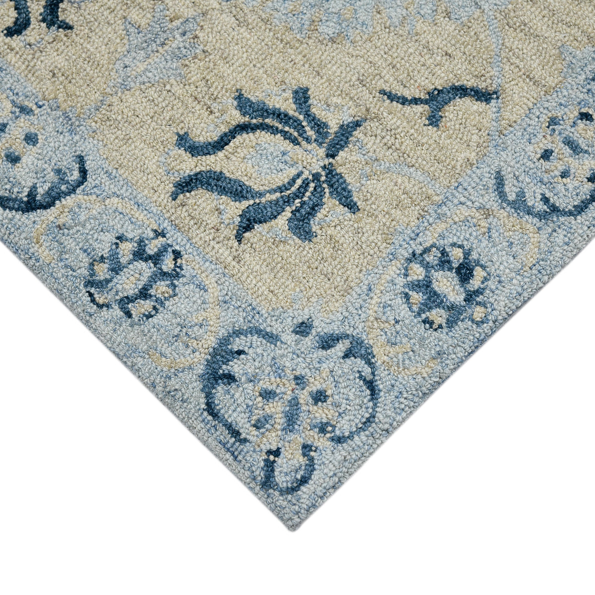 Light blue floral rectangle area rug corner with navy botanical motifs