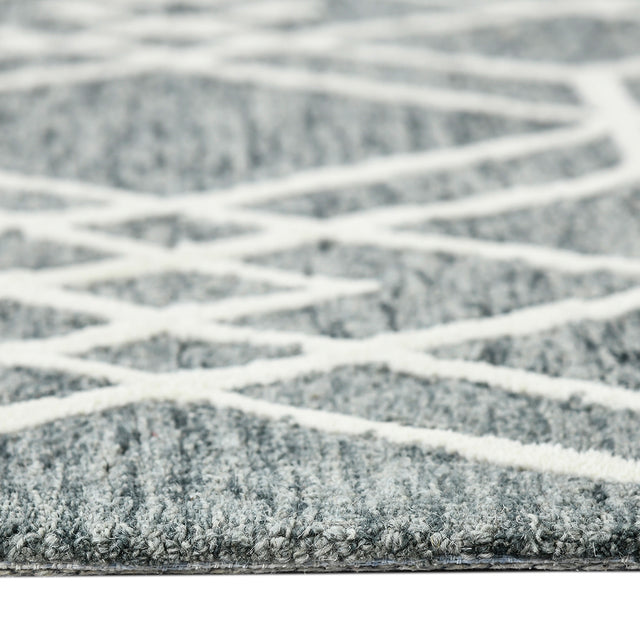 Low-angle view of gray geometric rug with off-white lattice pattern across surface
