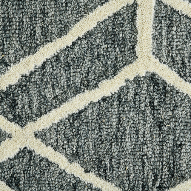 Close-up of textured gray rug with off-white diamond lattice pattern