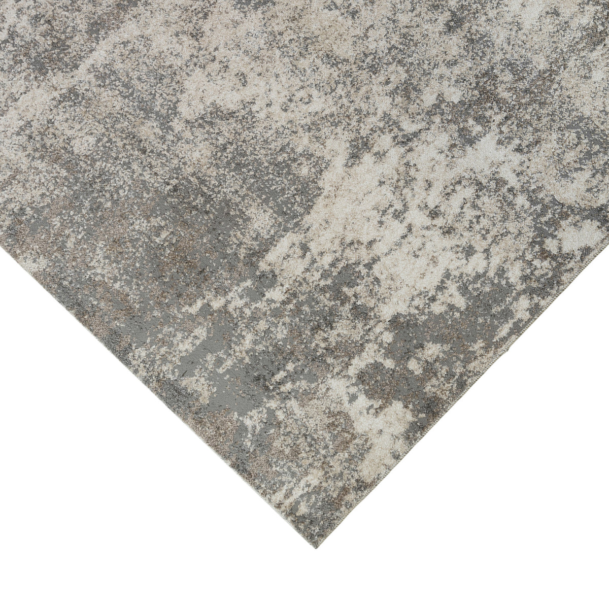 Corner of a light gray and beige area rug with abstract distressed look.