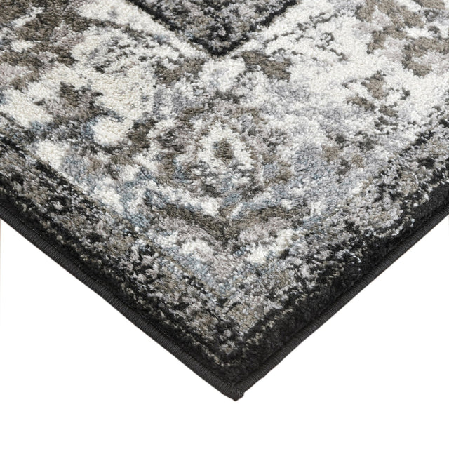 Black and ivory area rug corner with low-pile texture and border