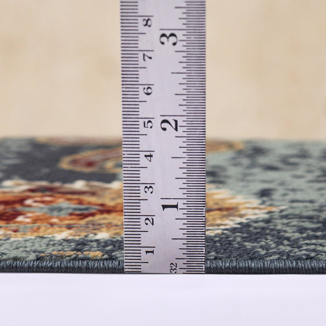 Area rug low-pile height measurement shown on teal blue rug with multicolor pattern