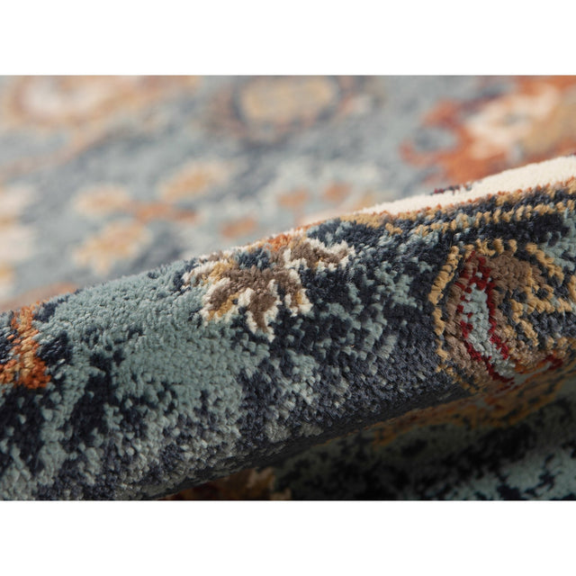 Side view of teal blue area rug showing low, dense plush pile and border detail