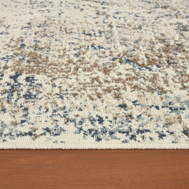 Low-pile area rug with speckled cream and blue abstract pattern