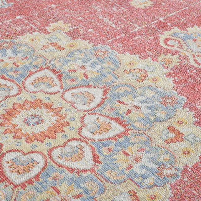 Vintage medallion rug pattern with burgundy red, light blue, yellow, and cream on textured weave