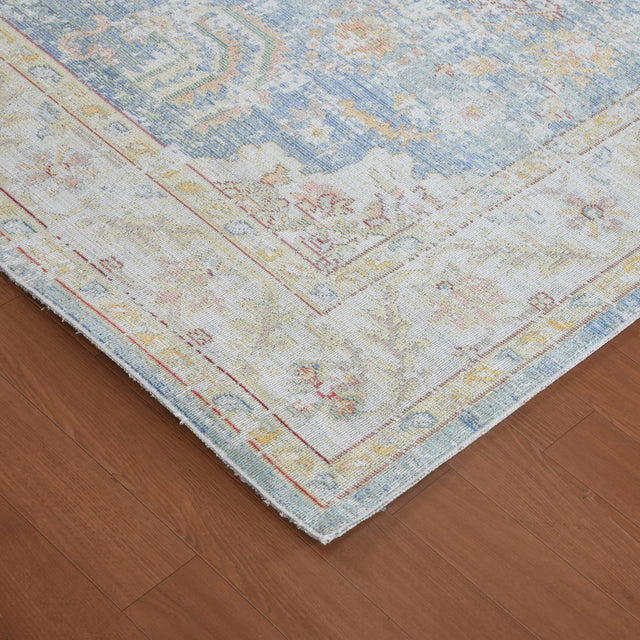 Corner of indigo blue and ivory rug with distressed medallion motif and border
