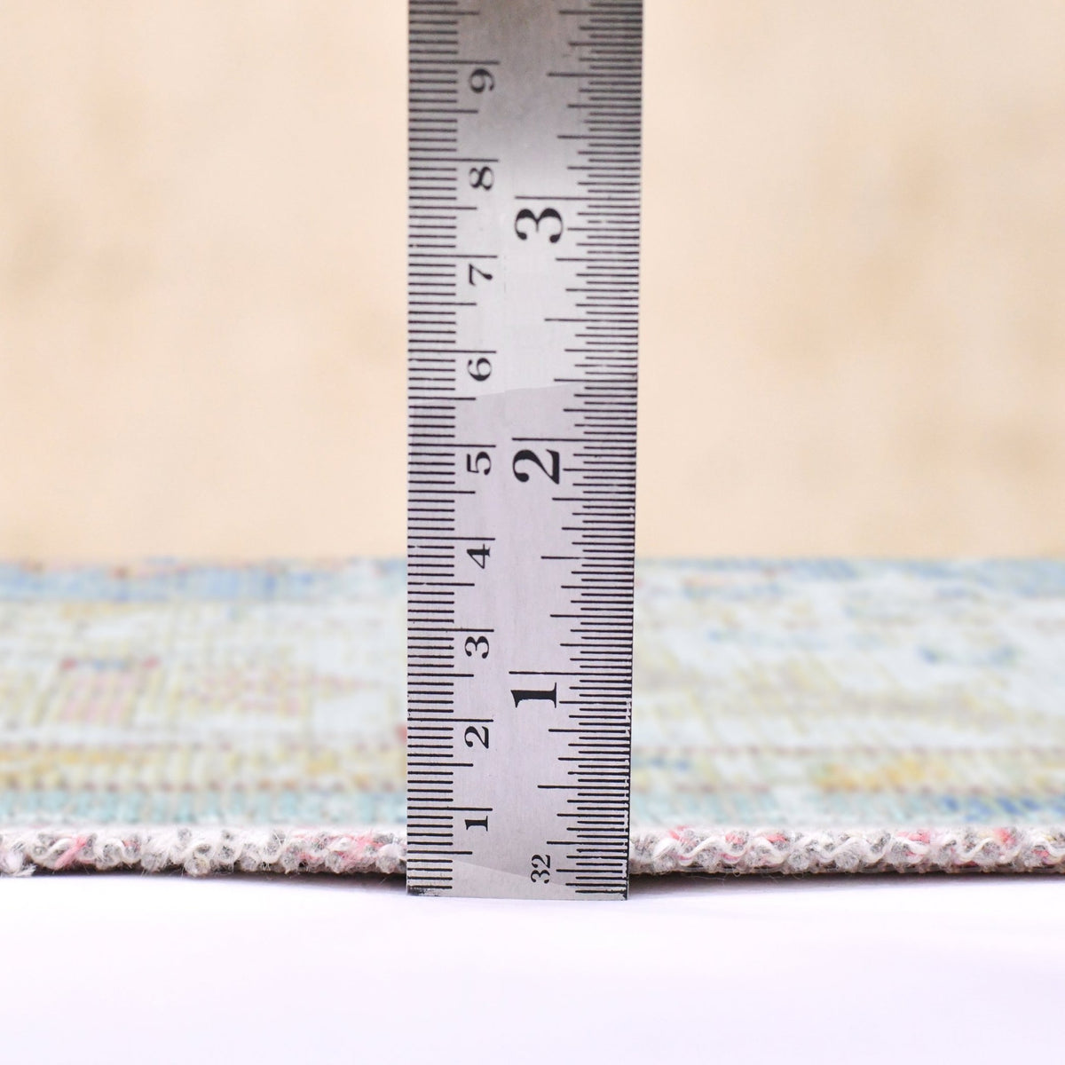 Indigo blue and ivory rug with textured border; includes height measurement ruler