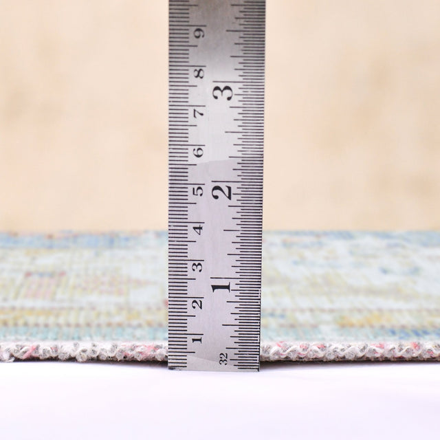 Indigo blue and ivory rug with textured border; includes height measurement ruler
