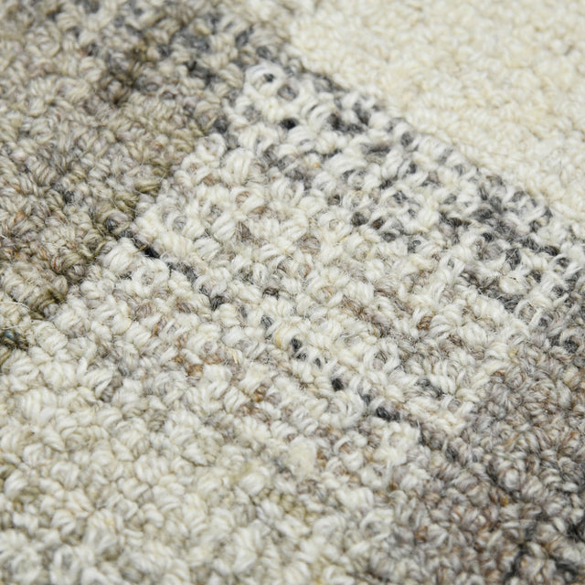 Sand and gray plaid hand-tufted rug with textured looped pattern detail.
