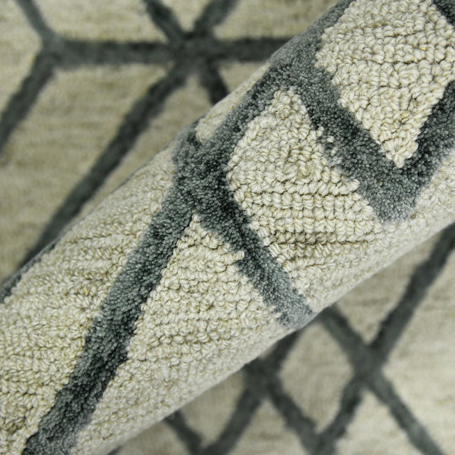 Ivory area rug with dark gray stripe and cross motif, closeup of folded edge