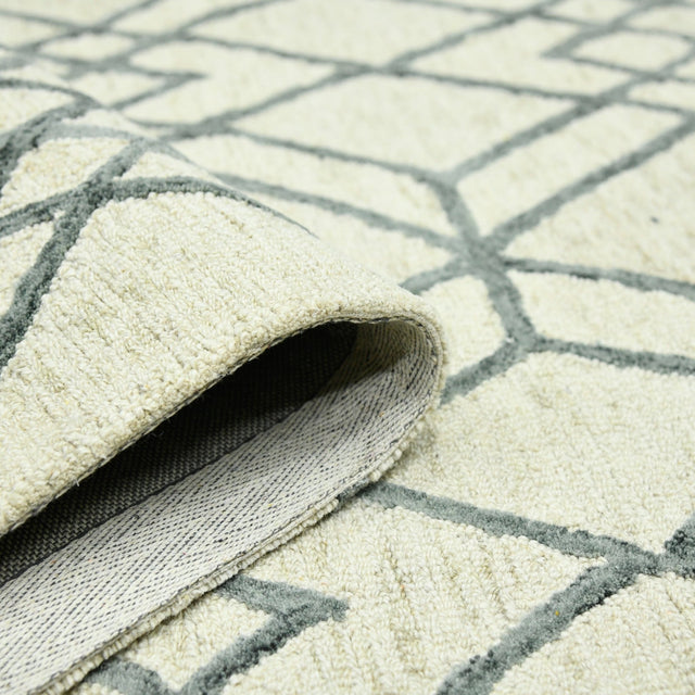 Ivory geometric area rug corner with dark gray line pattern and textured pile underside
