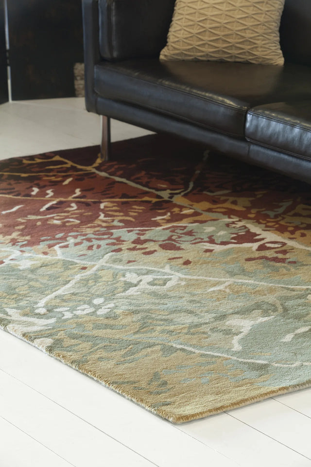 Chandra Nirvana NIR-6604 Green and Red and Burgundy and Brown rug, shown in a styled room setting