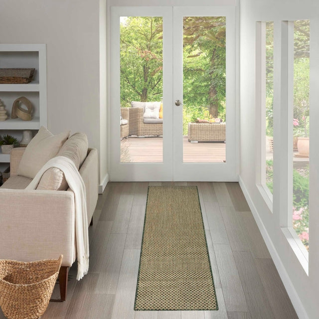 Green patterned runner rug with diamond lattice design, laid along a hallway floor