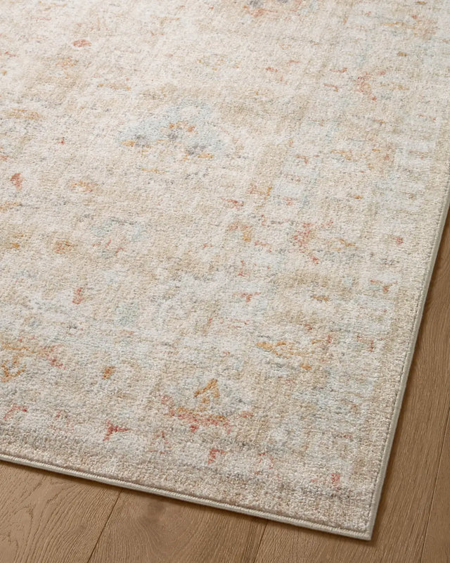 Loloi Monroe Mon-05 Sand/Sunrise Rug - angled corner on wood