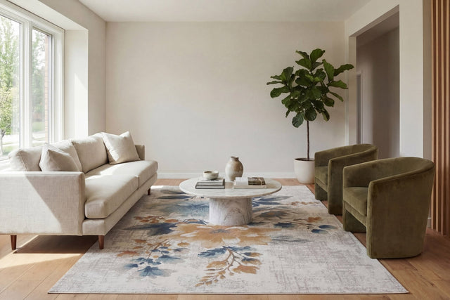 Rectangular cream rug with blue and tan abstract floral pattern