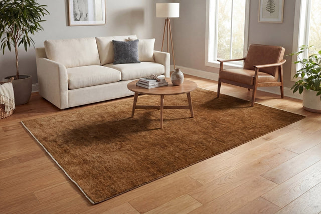 Rust-brown rectangular traditional area rug with subtle border and dense pile
