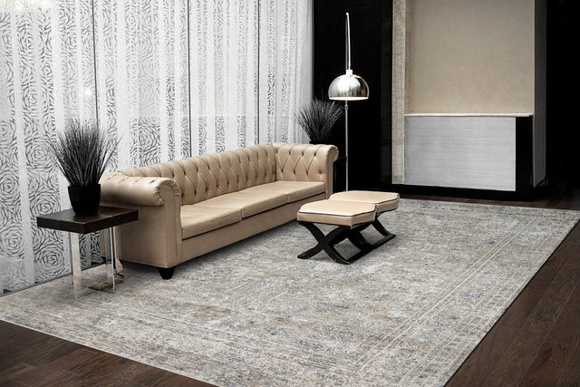 Traditional power-loomed area rug with beige, ivory, and blue pattern
