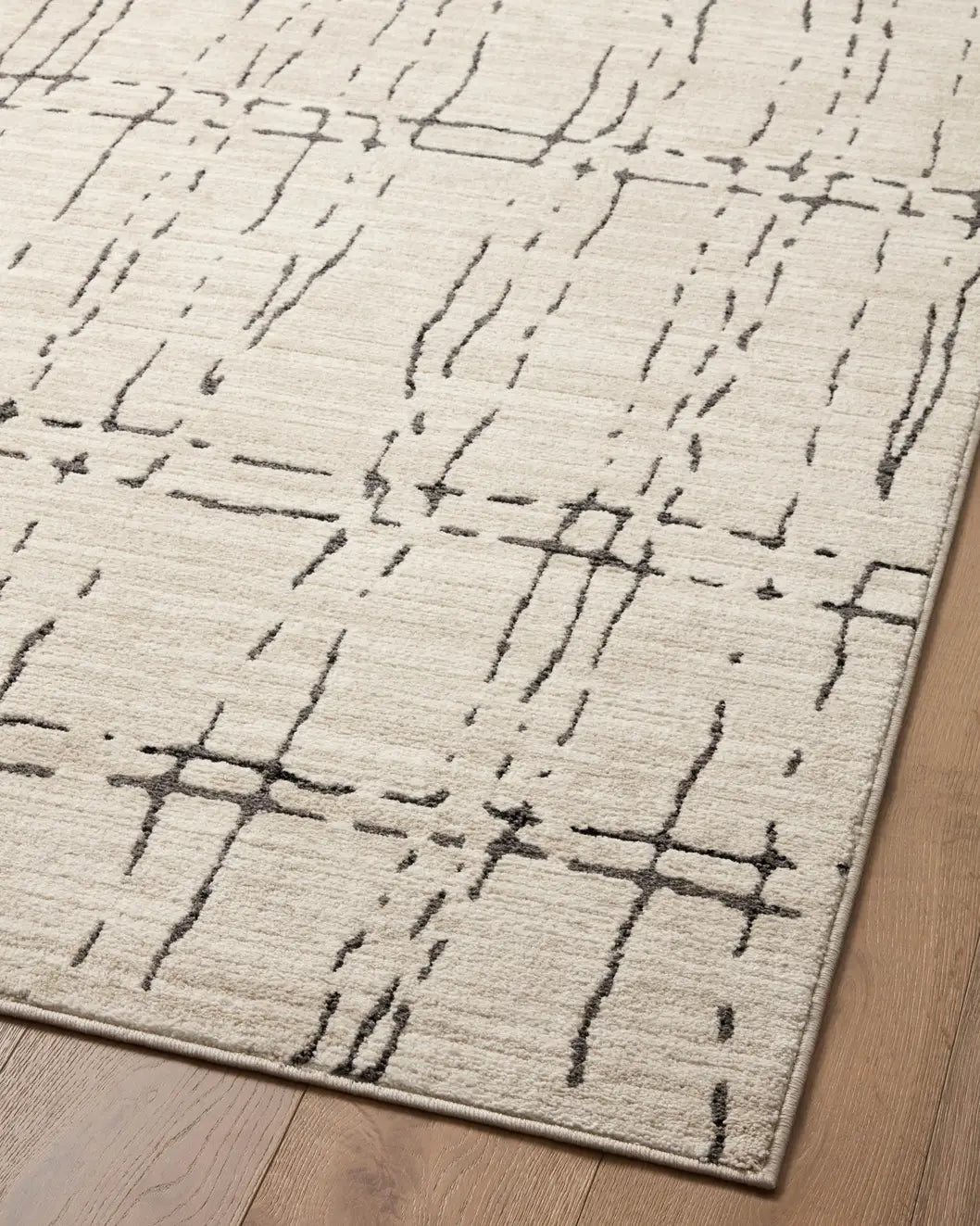 Loloi Darby Dar-06 Sand/Dk. Grey Rug - angled corner on wood