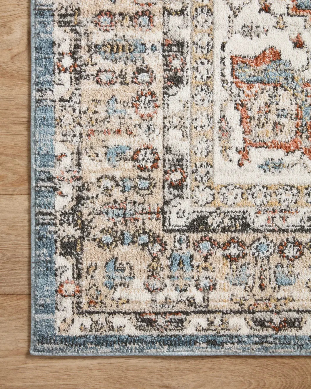 Loloi Odette Odt-06 Sky/Multi Rug - corner on wood