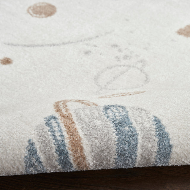 Ivory rug close-up showing blue and brown planet stripe prints on textured pile