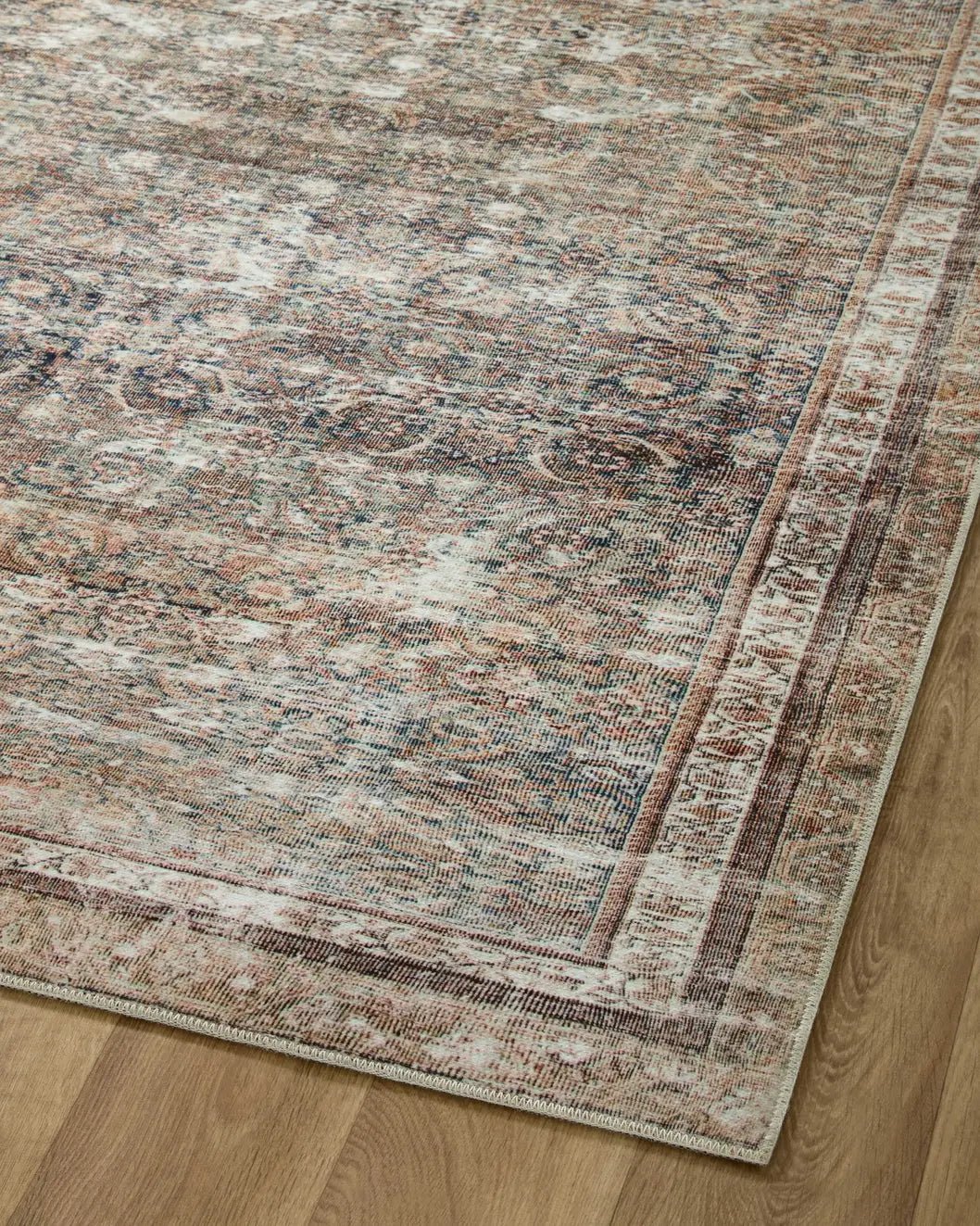 Chris Loves Julia x Loloi Jules 9-Jul Ink / Terracotta Rug - angled corner on wood