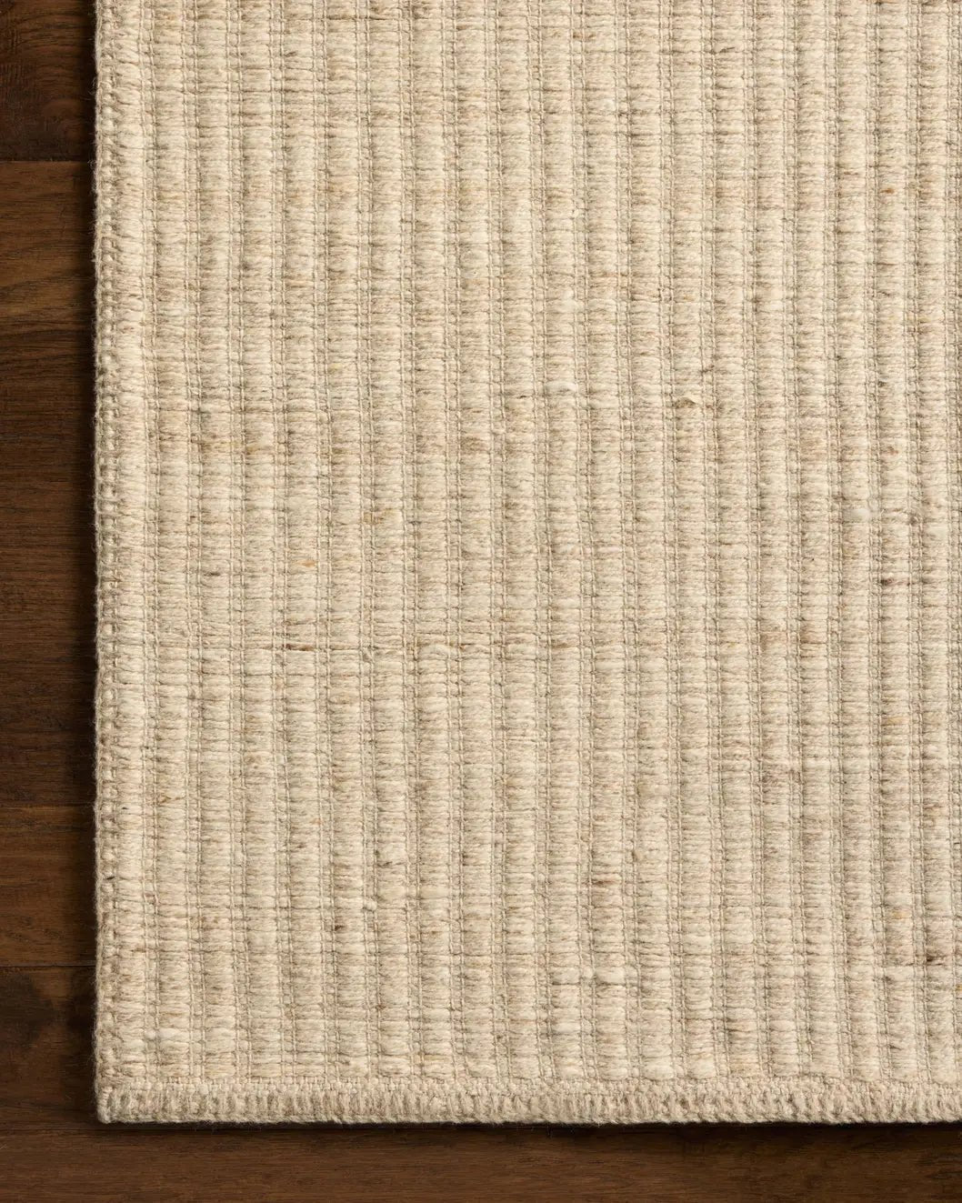 Loloi Elma ELM-01 Contemporary Hand Woven Bone Rug - corner on wood