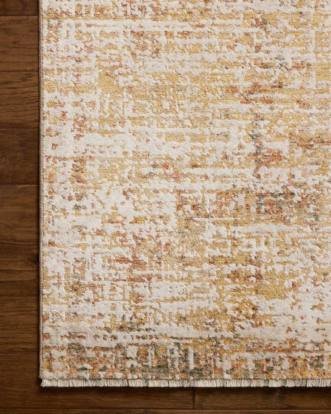 Loloi Nellie NEL-02 Sunset / Pebble Rug - corner on wood