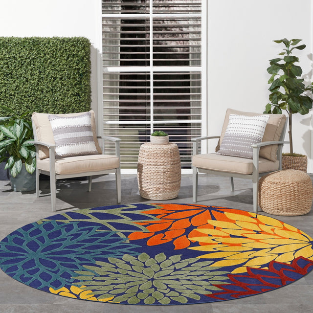 Nourison Aloha multicolor round rug, navy base with orange and yellow floral motif