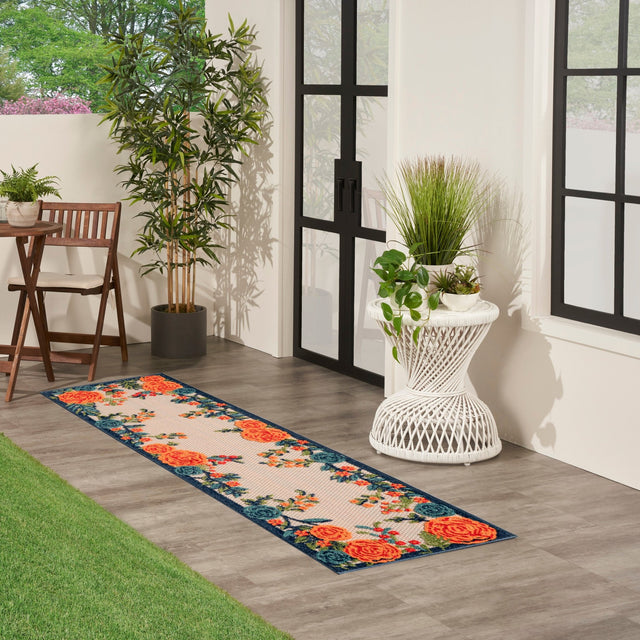 Rectangular floral rug featuring orange roses, green leaves, and blue border trim