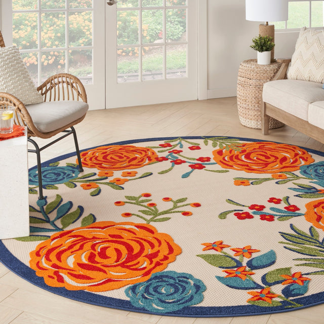 Round floral area rug close-up with orange roses, green sprigs, and blue edging