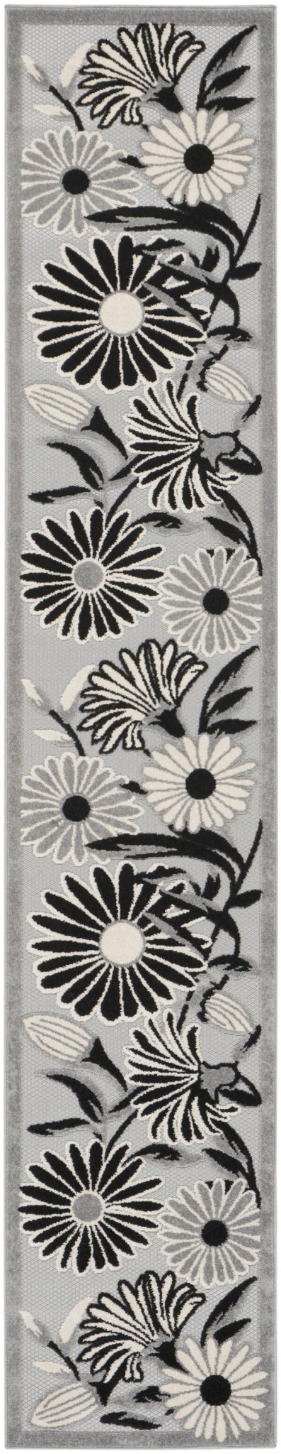 Black-and-white floral rug with layered daisy and leaf linework, close-up