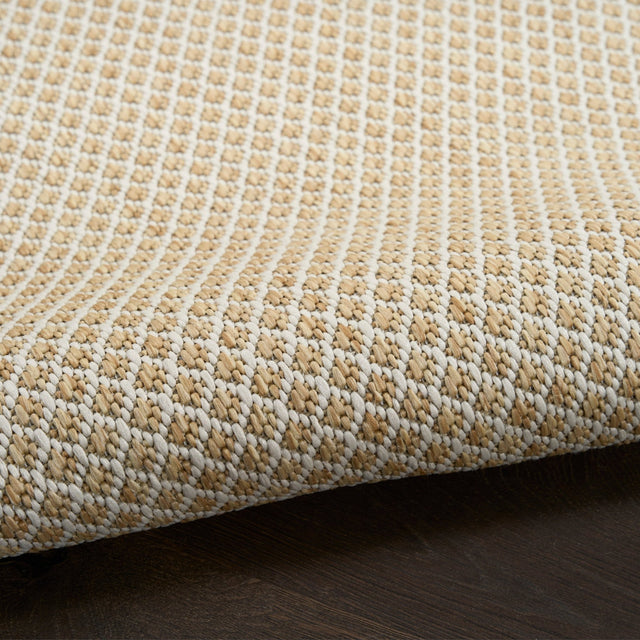 Close-up of natural woven rug with dense lattice stitching and textured pile