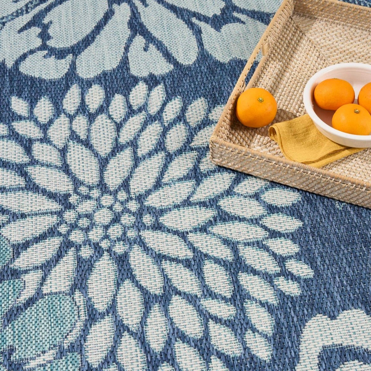 Navy and light blue floral area rug with textured weave and close-up flower motif