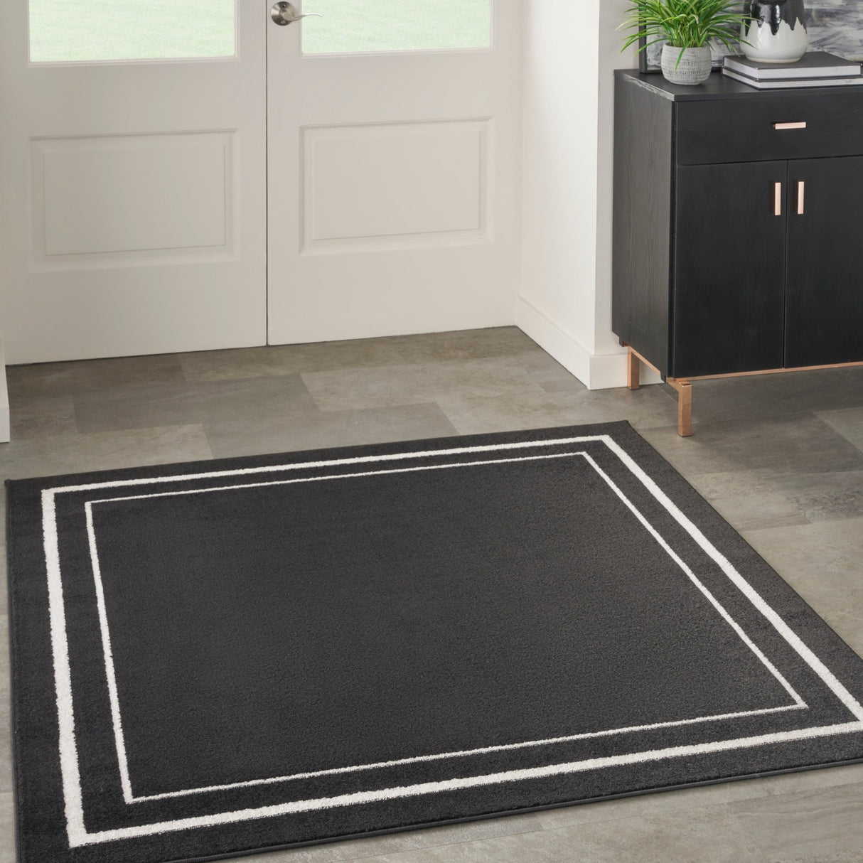 Black and ivory rectangular rug with double-line inner border
