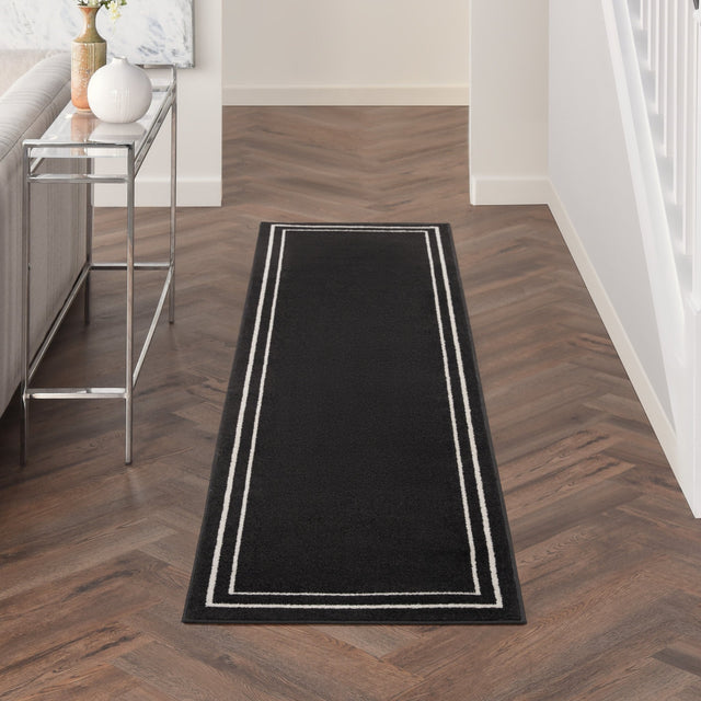Black and ivory rectangular runner rug with stacked border lines