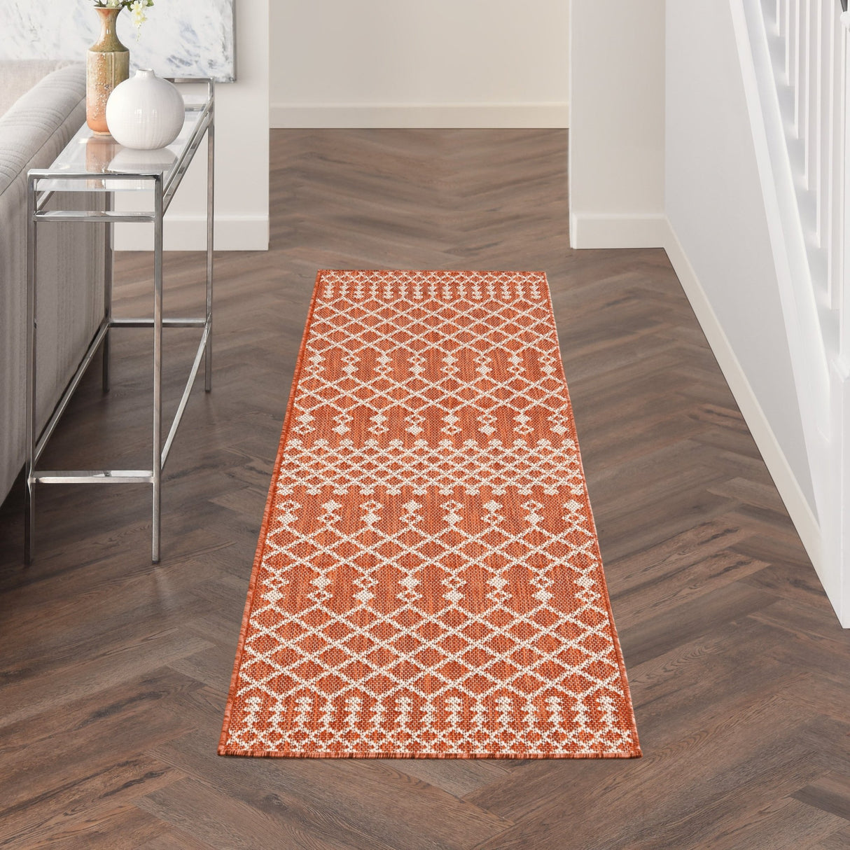 Terracotta rectangular rug with repeating white diamond lattice pattern