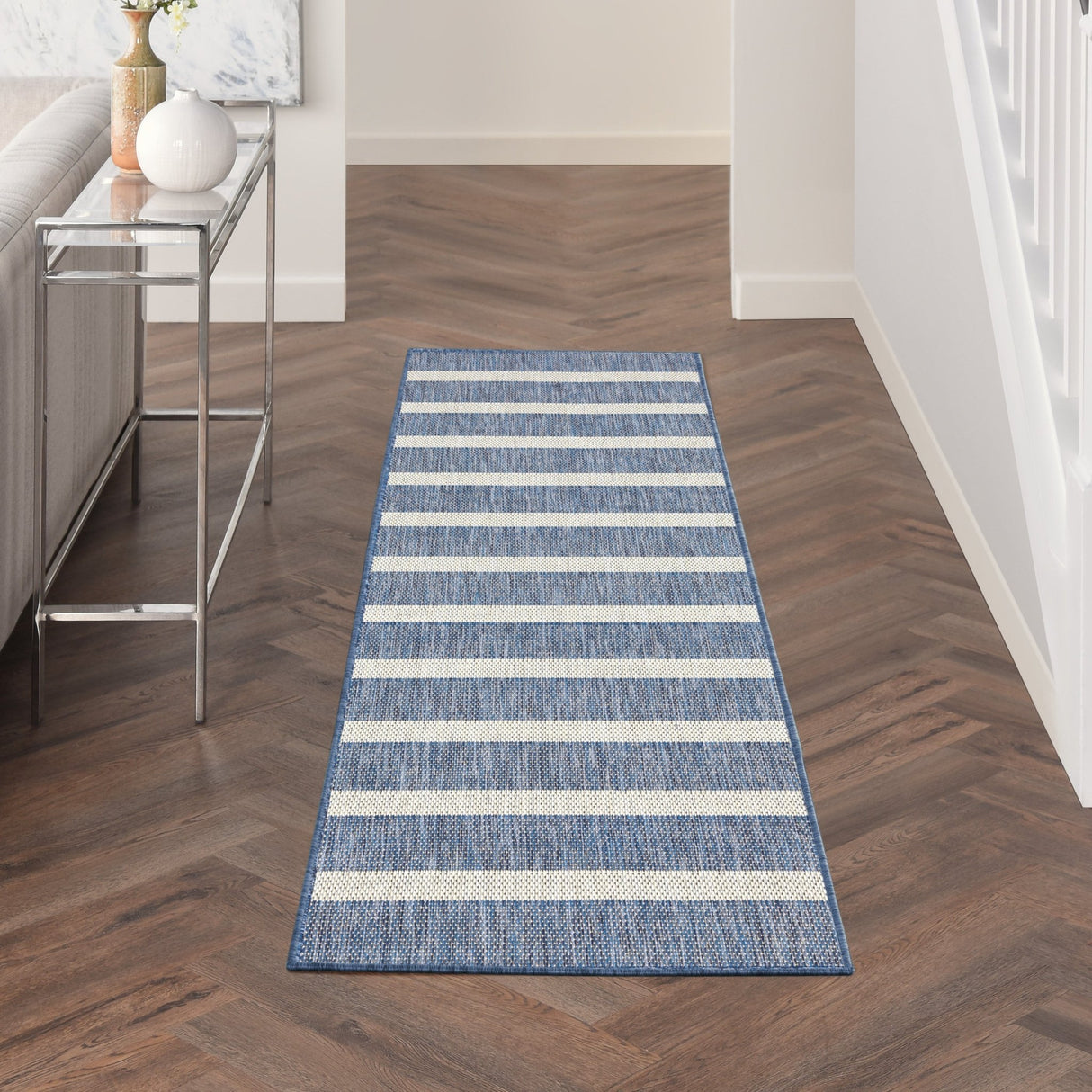 Rectangular navy and ivory striped runner rug with bordered edges