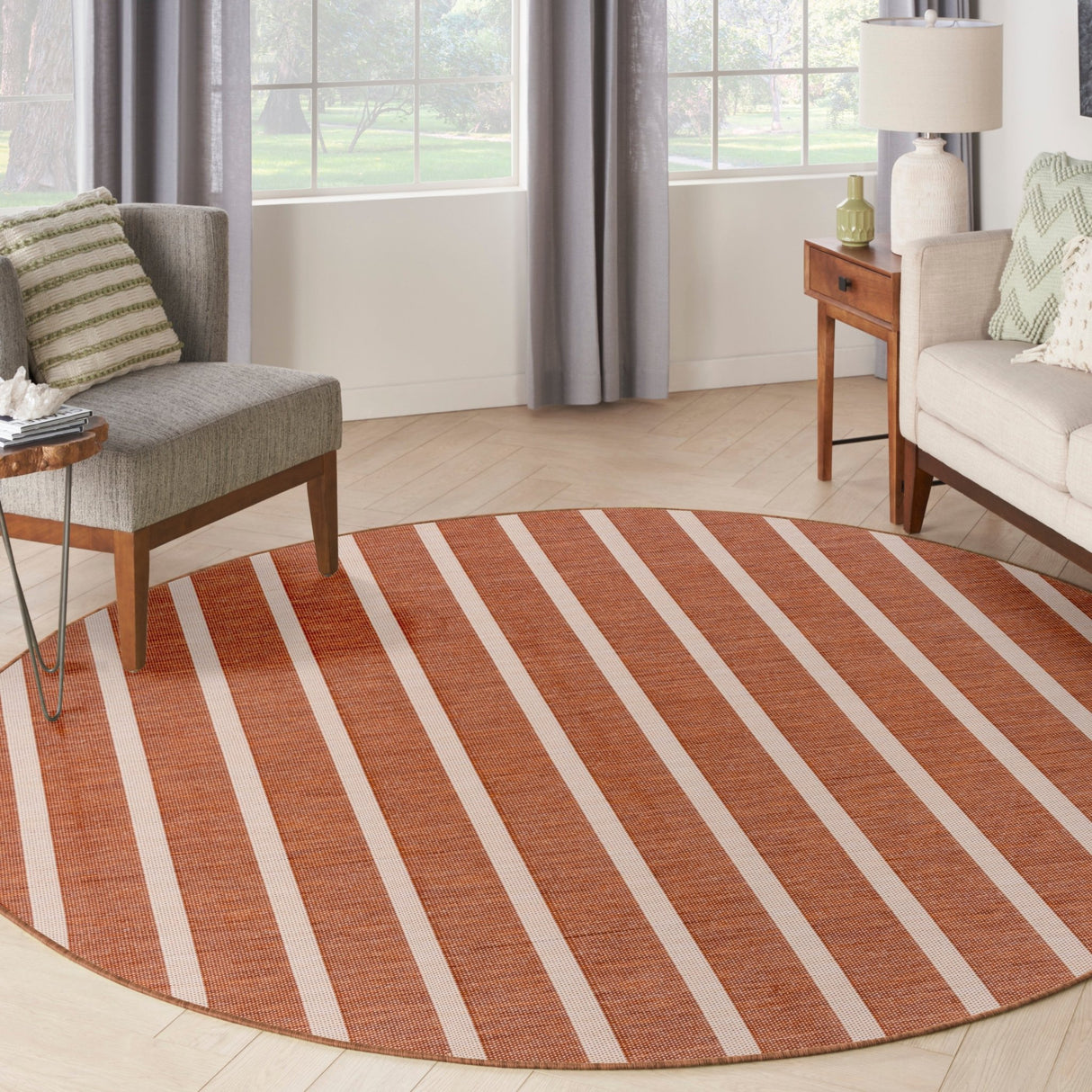 Round terracotta and ivory striped area rug with wide horizontal bands