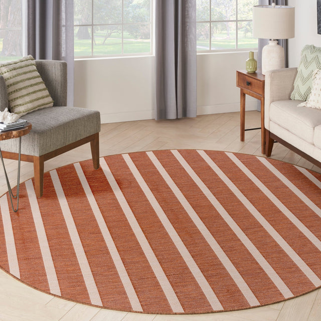 Round terracotta and ivory striped area rug with wide horizontal bands