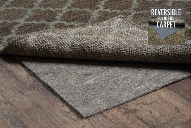 Reversible grey rug pad with textured surface, shown with folded edge