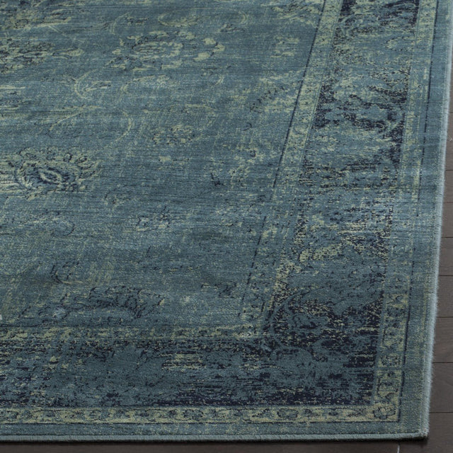 Vintage-style rug surface in blue-teal with distressed ornamental lines and texture