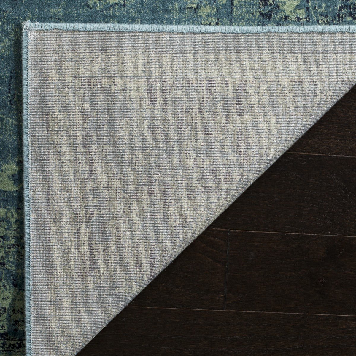 Vintage-style rectangular rug with light blue and teal distressed pattern